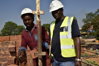 Alex Phatudi Corobrik Building Training Co-ordinator on site at Thembelihle Village assists Eric Mambane with the techniques of building a brick wall.